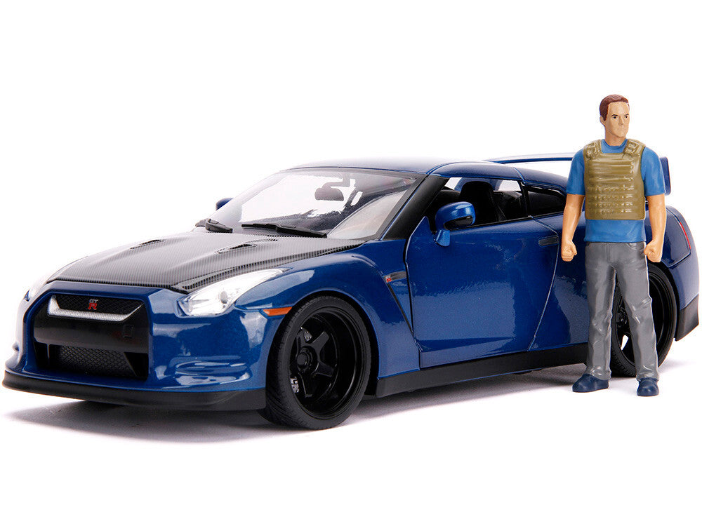 Blue sports car with a figure wearing a blue shirt and beige vest on a white background
