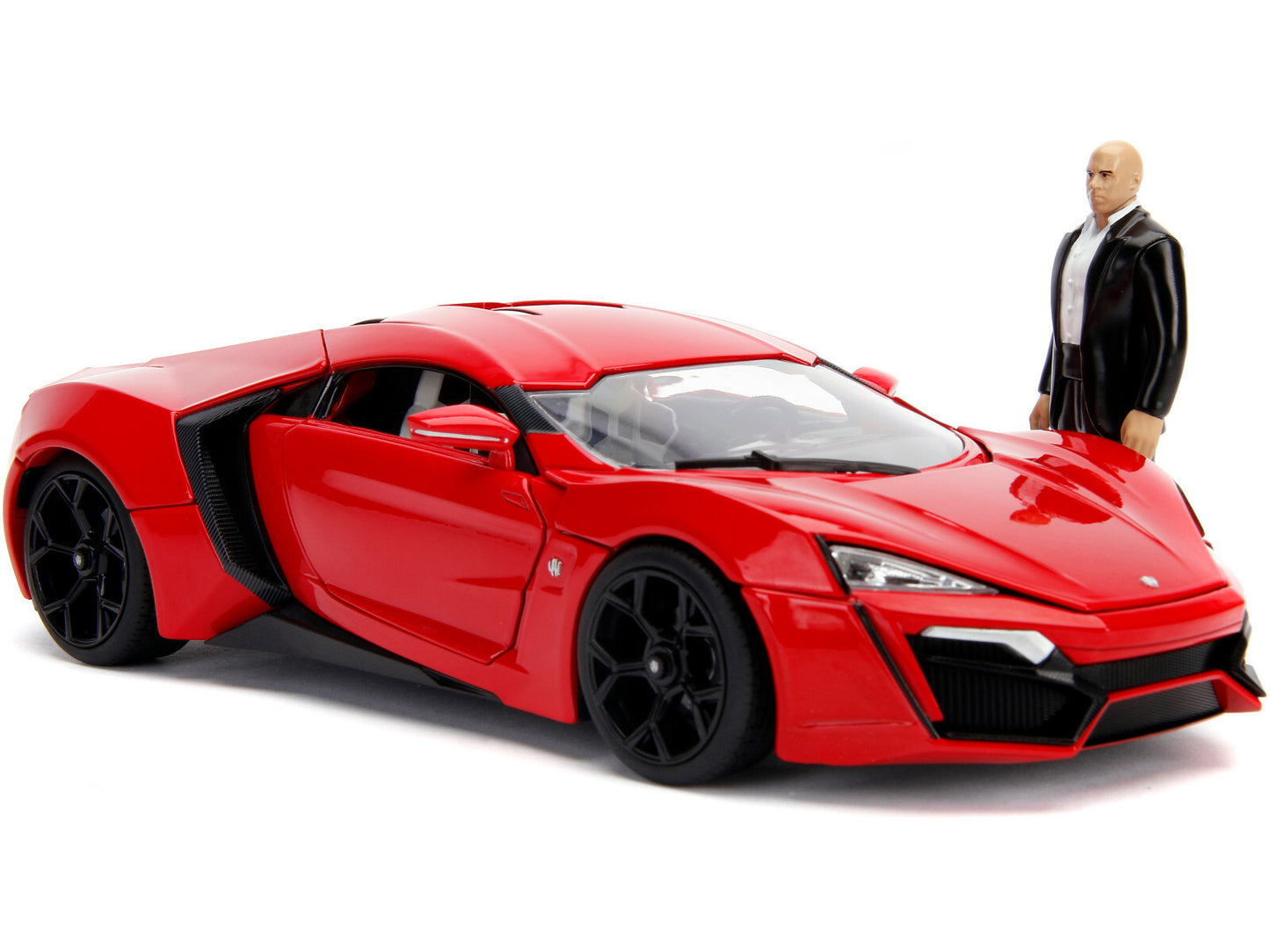 Red sports car model with a figure standing next to it on a white background