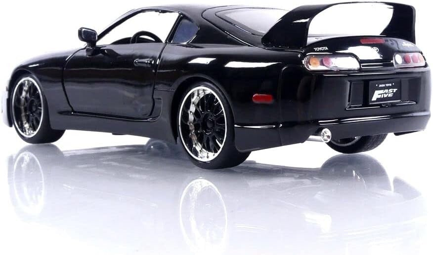 Black sports car on a reflective white surface