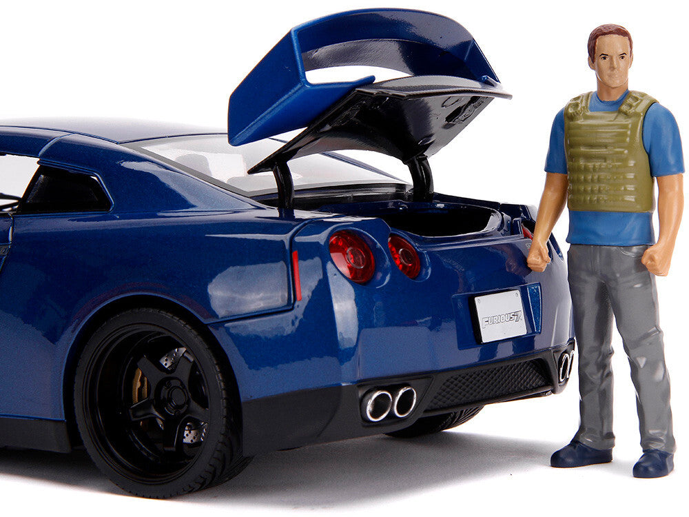 Blue sports car with open trunk and a figure standing next to it on a white background