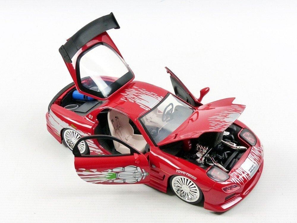 Red toy car with open doors on a white background