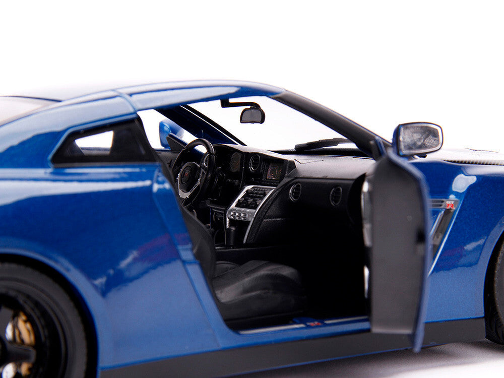 Blue sports car with open door on a white background
