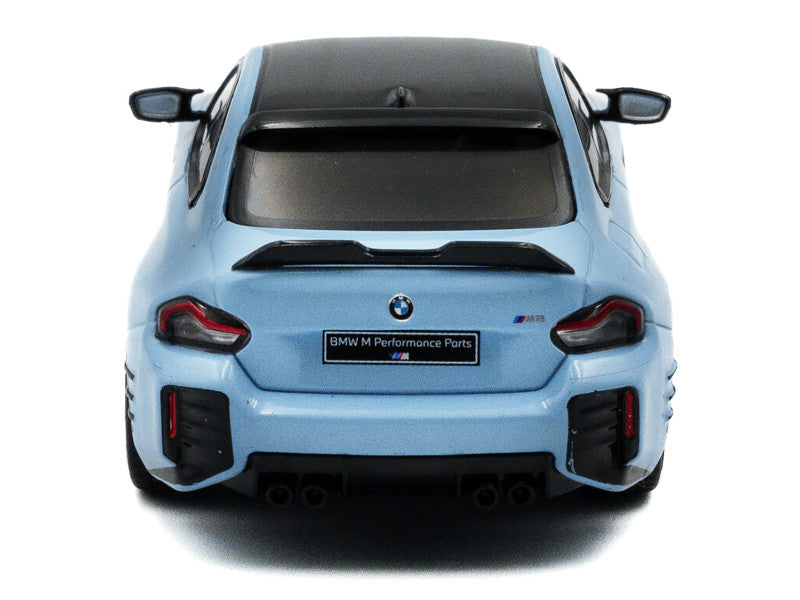 Back view of a light blue BMW car with visible branding on a white background