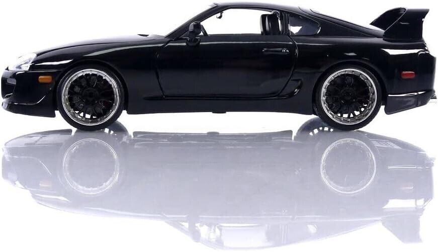 Black sports car on a reflective white surface