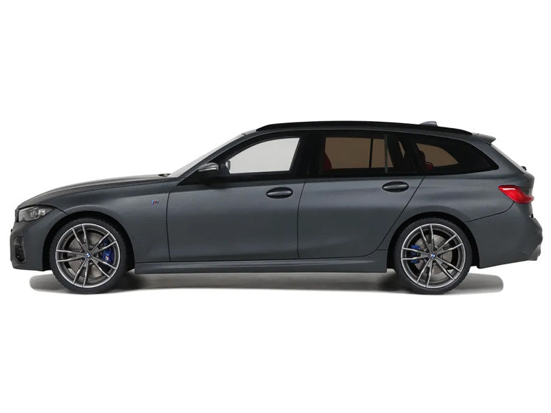 Side view of a dark gray car on a white background