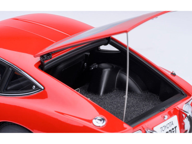 Red toy car with open door showing interior details on a white background