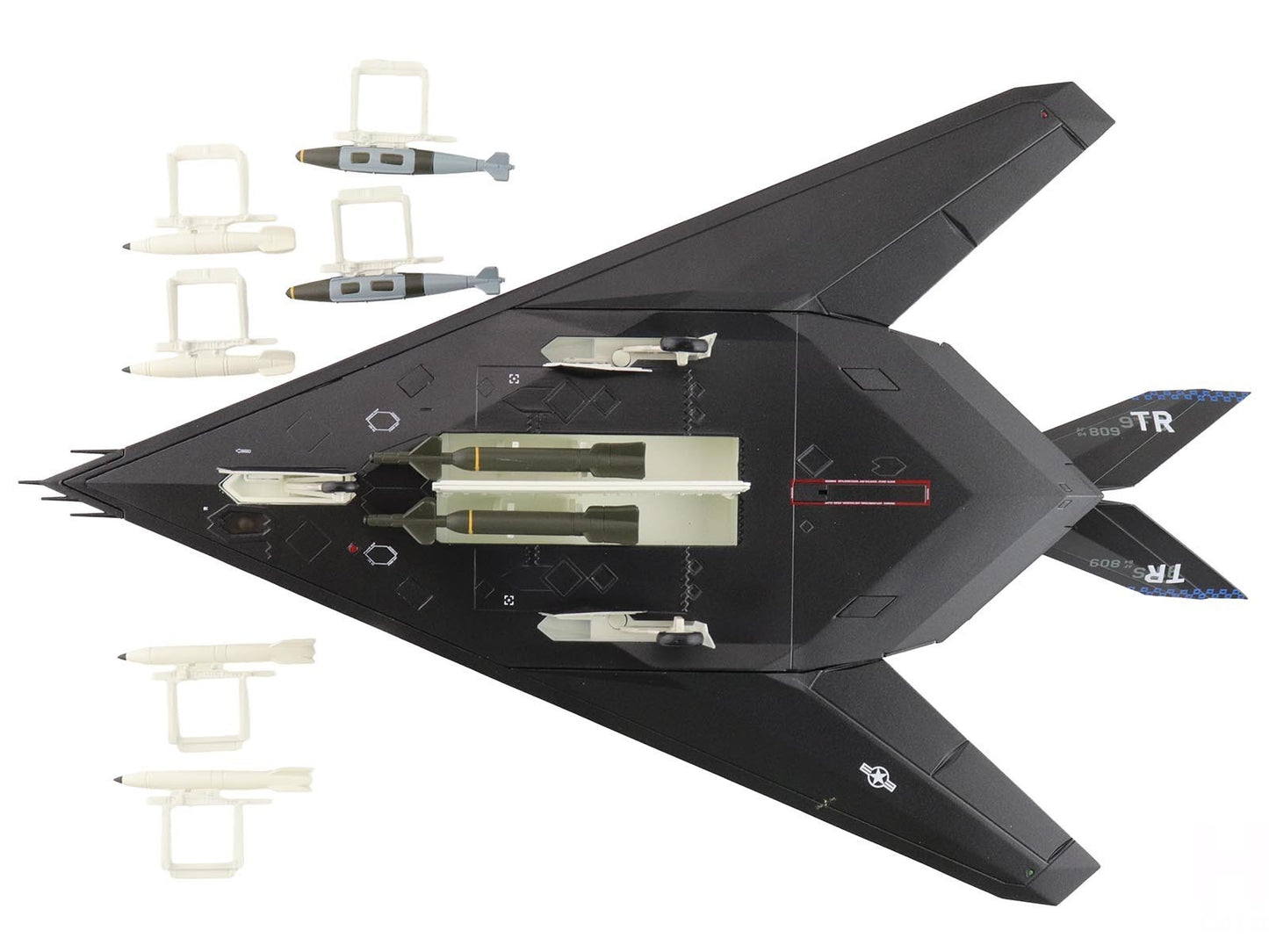 Black fighter jet model with attached missiles on a white background