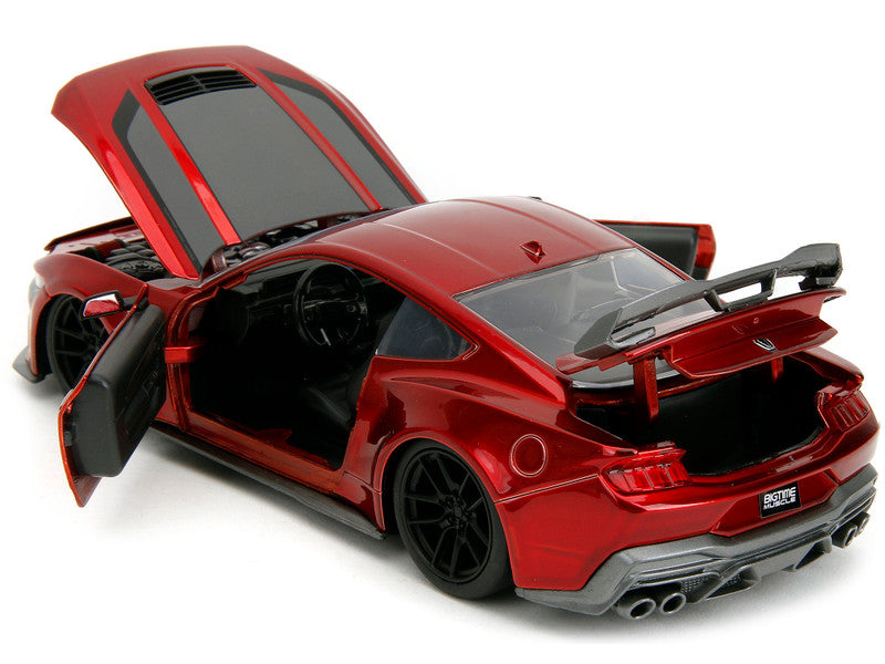 Red sports car model with open doors on a white background
