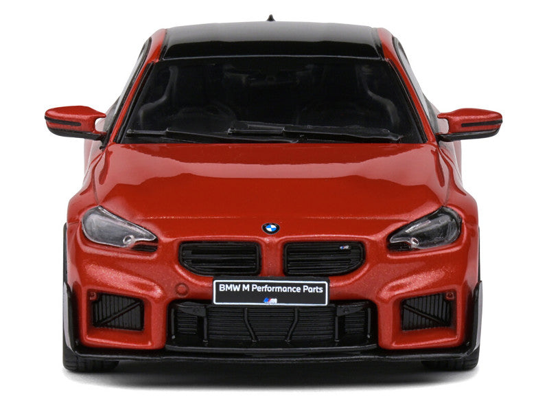 Red BMW car with 'BMW M Performance Parts' badge on a white background