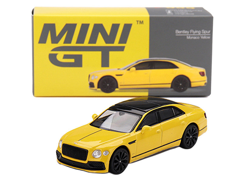 Yellow model car with 'MINI GT' packaging on a white background