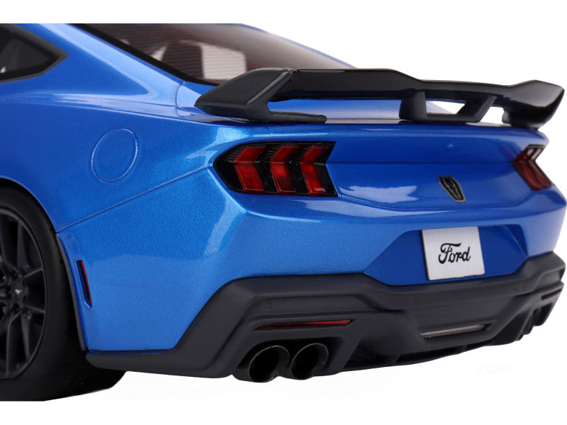 Blue Ford car with a black spoiler on a white background