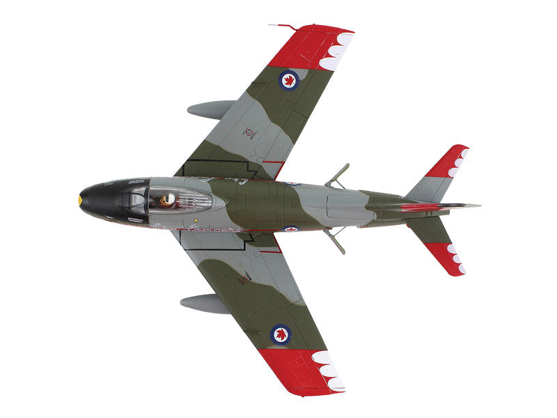 Model of a military aircraft with camouflage pattern on a white background