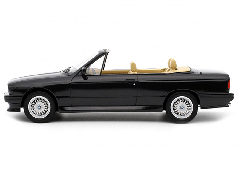Black convertible car with beige interior on a white background