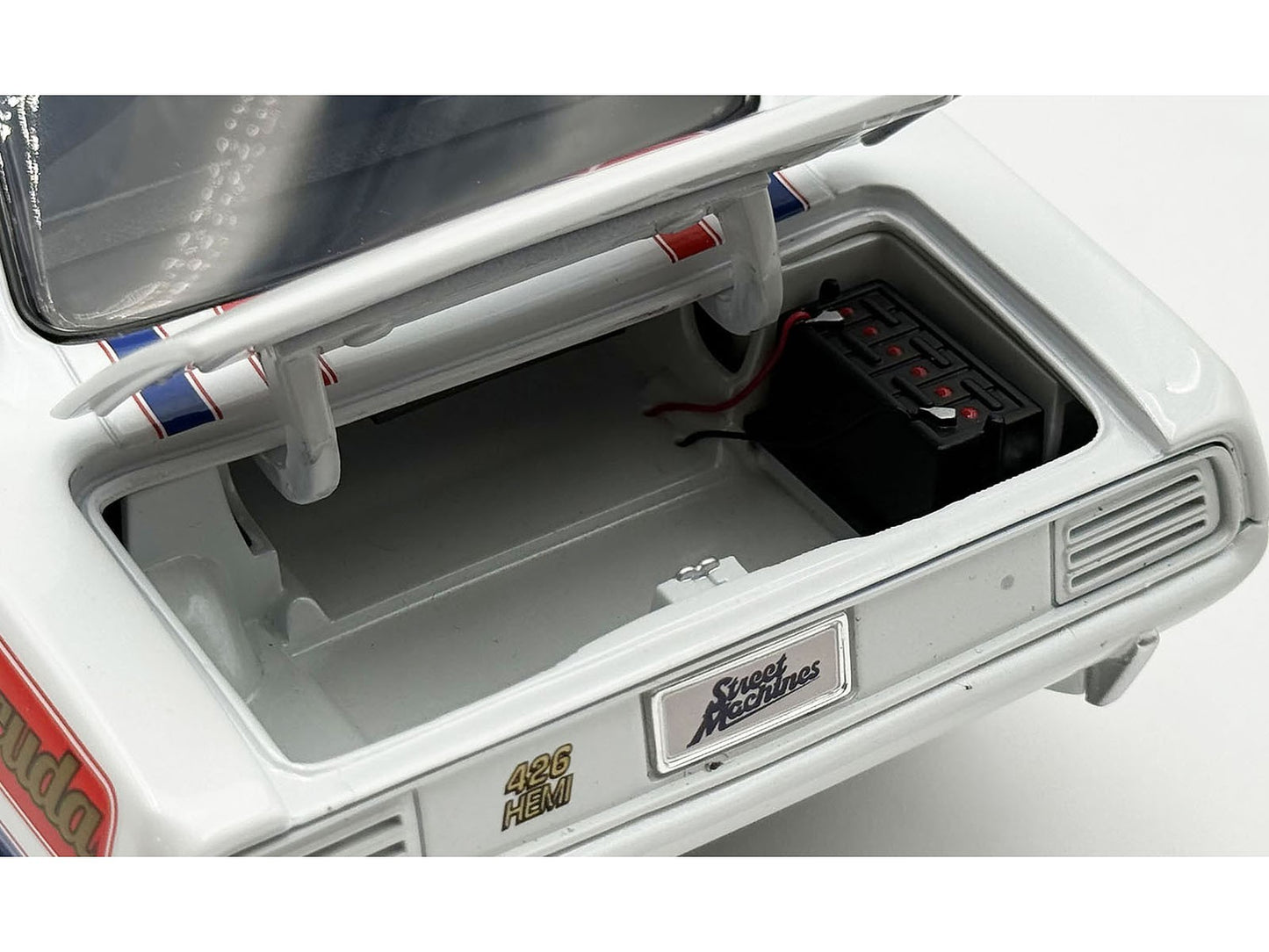 Close-up of a model car's interior with visible branding on a white background