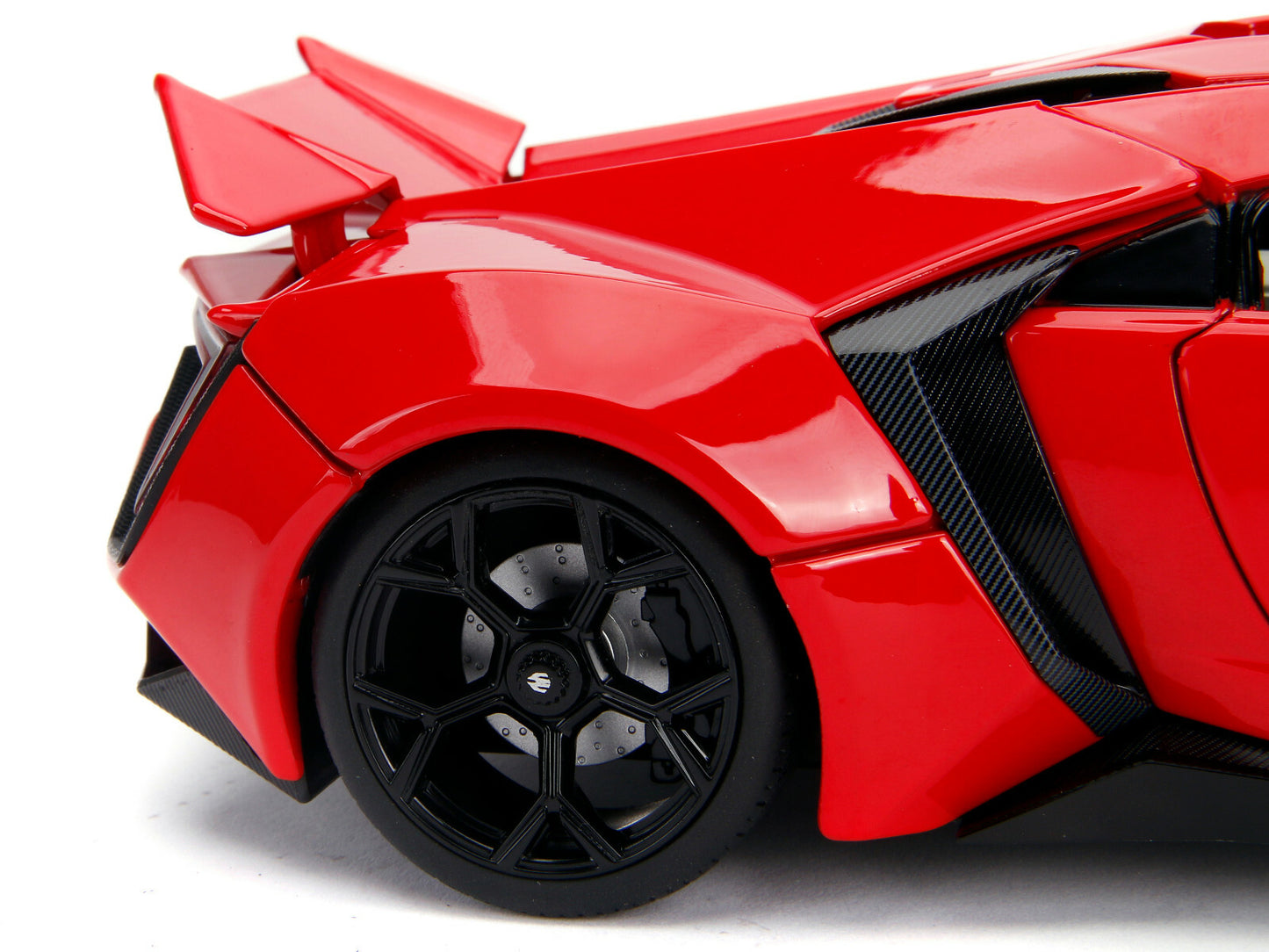 Red toy car with black wheels on a white background
