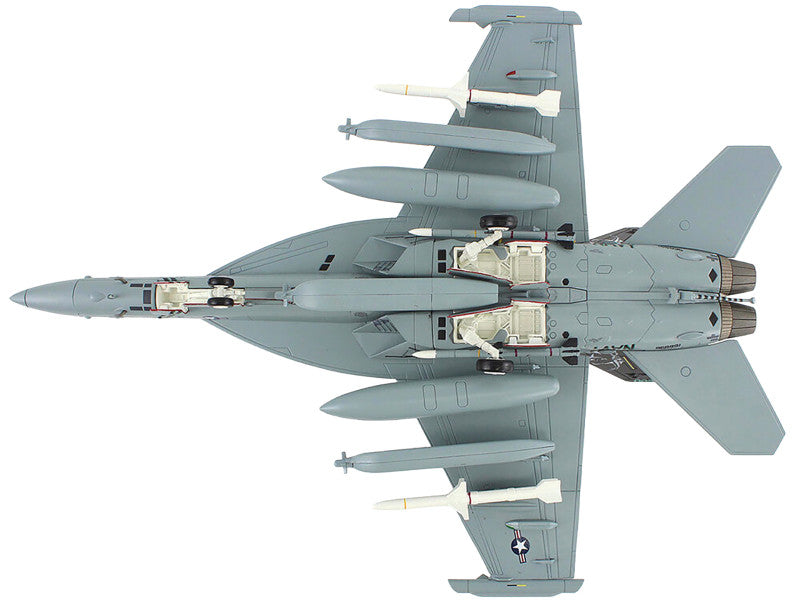 Top-down view of a fighter jet with weapons on a white background