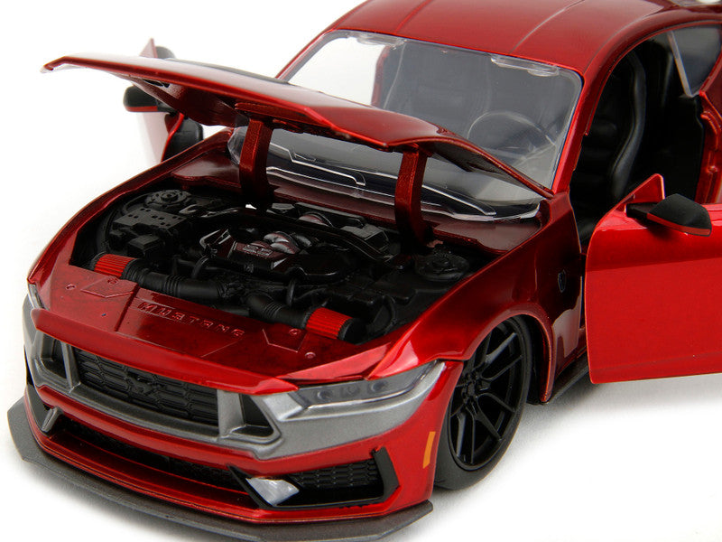 Red car model with open hood on a white background