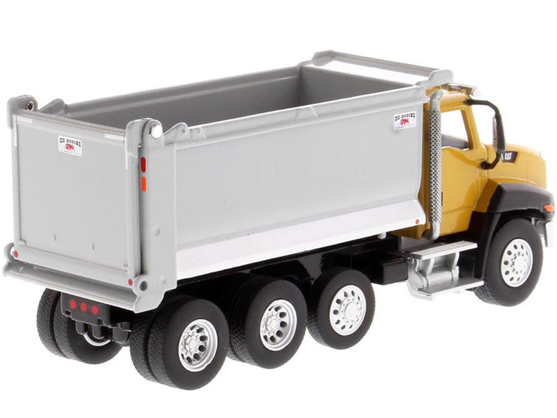 Model dump truck with a gray bed and yellow cab on a white background