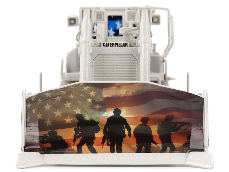 Caterpillar bulldozer with American flag and soldier silhouettes on the front