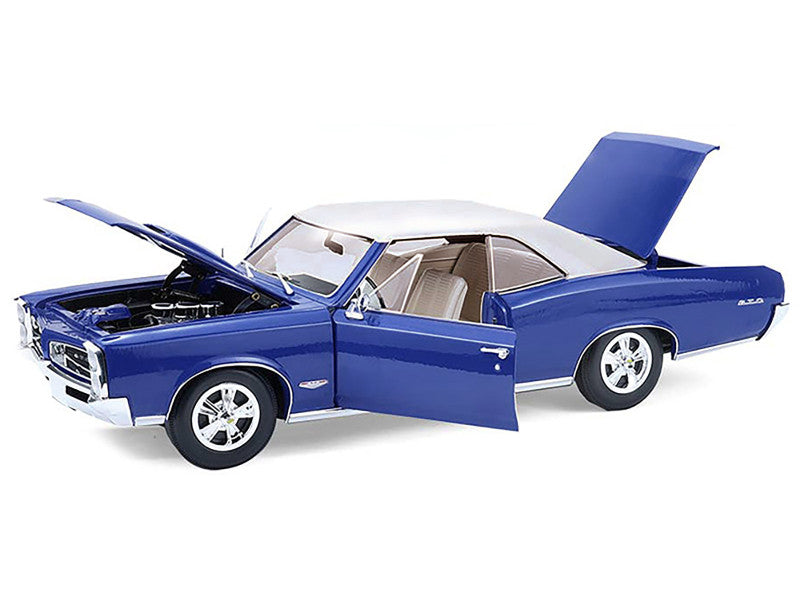 Blue and white model car with open doors and hood on a white background