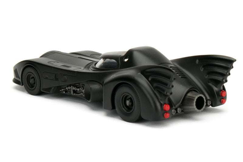 Black toy Batmobile on a white background