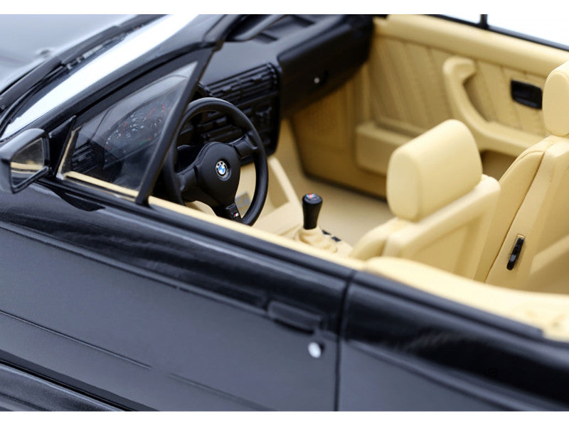 Car interior with beige seats and black steering wheel, featuring a BMW logo.