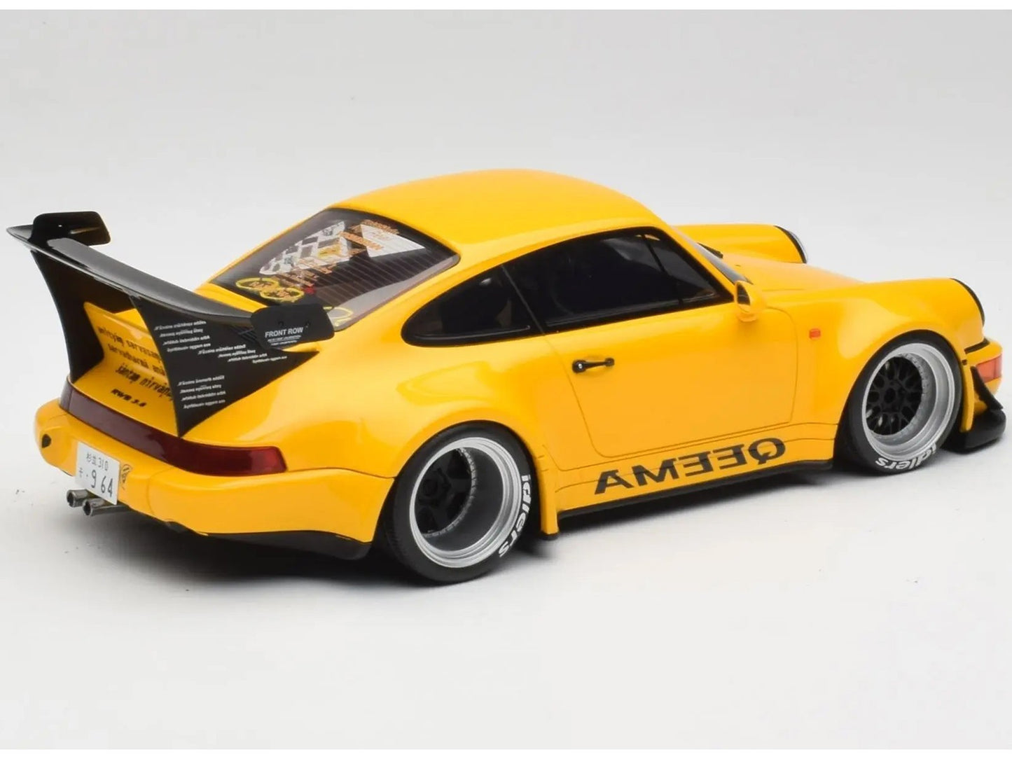Yellow model car with AME30 branding on a gray background