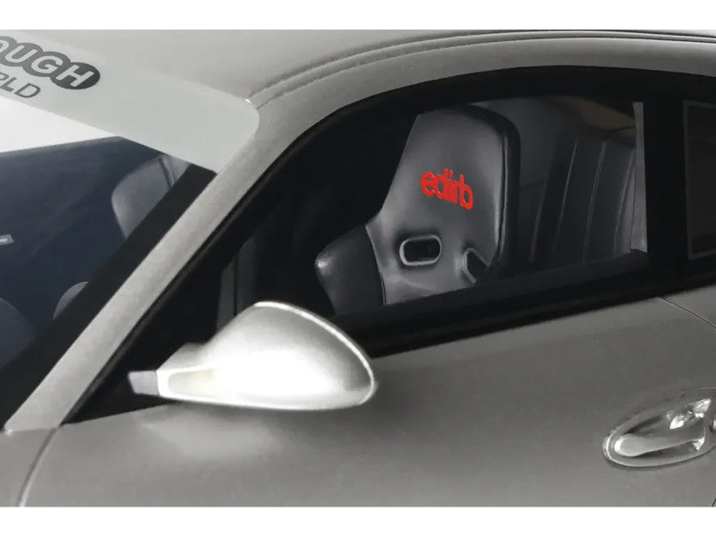 Car side mirror with 'ectib' branding inside a vehicle