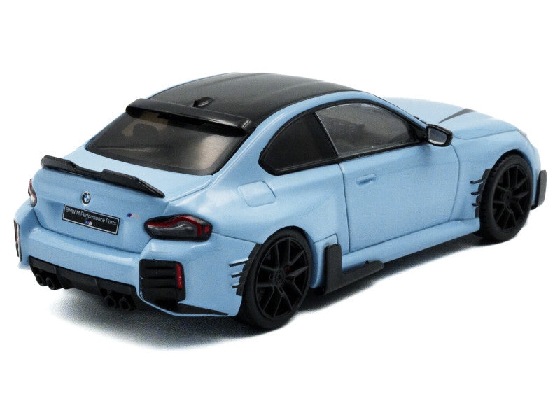 Light blue model car with black accents on a white background