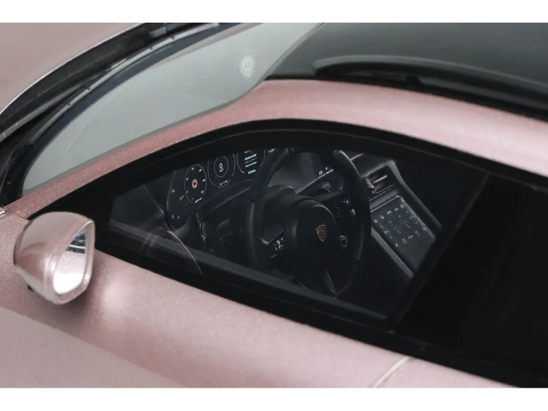 Close-up of a car's dashboard and steering wheel with a pink interior.