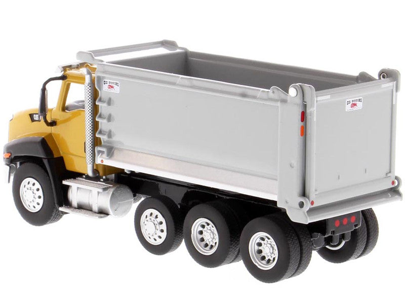 Model dump truck with yellow cab and gray bed on a white background