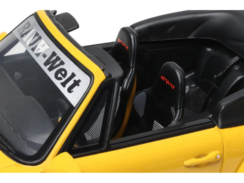 Yellow car with open door, interior visible, and 'Welt' branding.