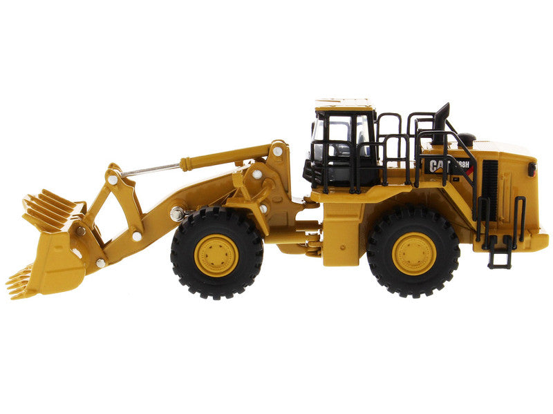 Model of a yellow Caterpillar loader on a white background
