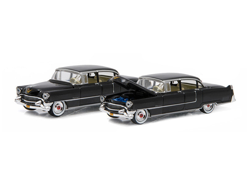 Two black classic cars on a white background