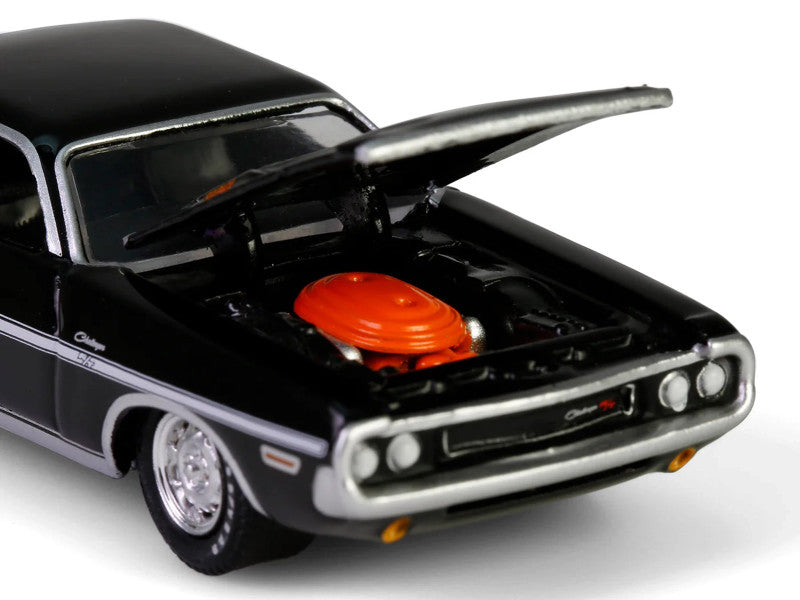 Black model car with open hood featuring a red engine on a white background