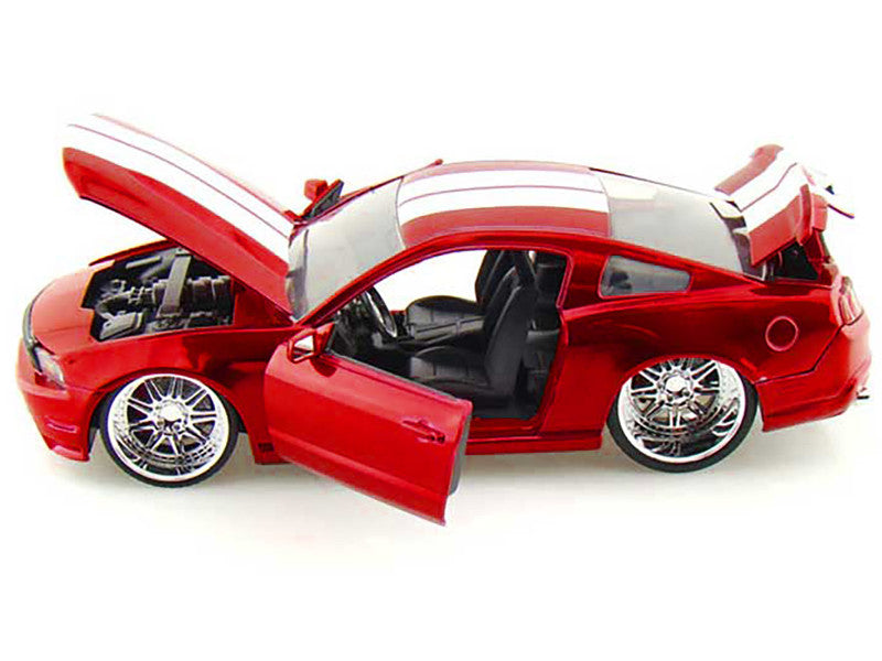 Red model car with open doors on a white background