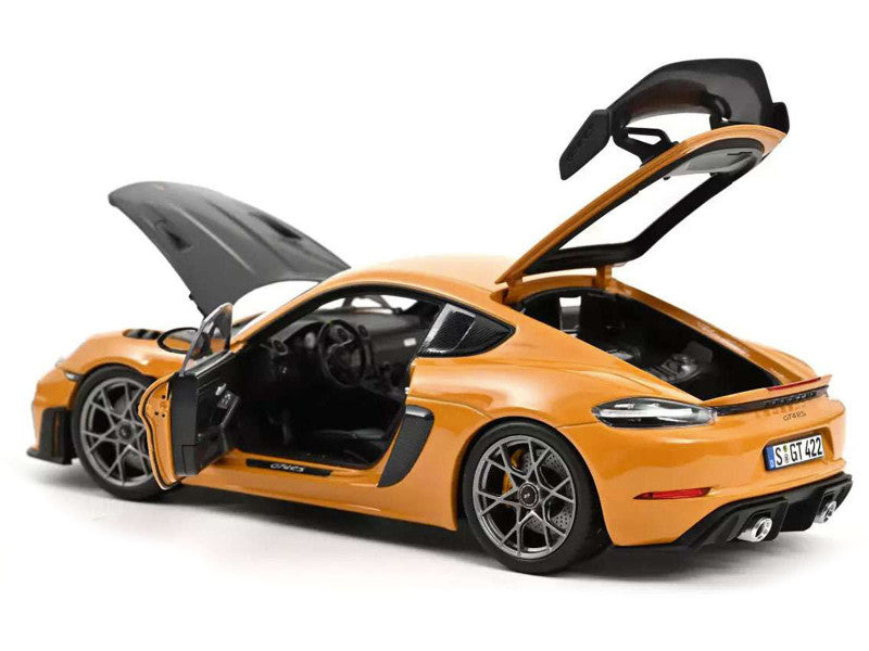 Orange sports car model with open doors on a white background