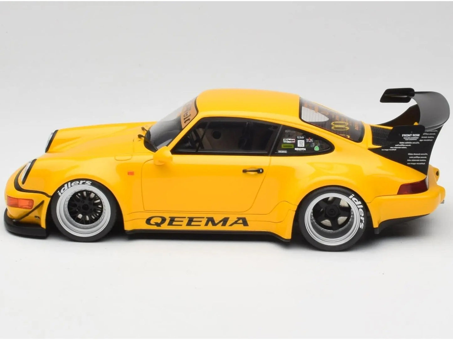 Yellow model car with 'QEEMA' branding on a gray background