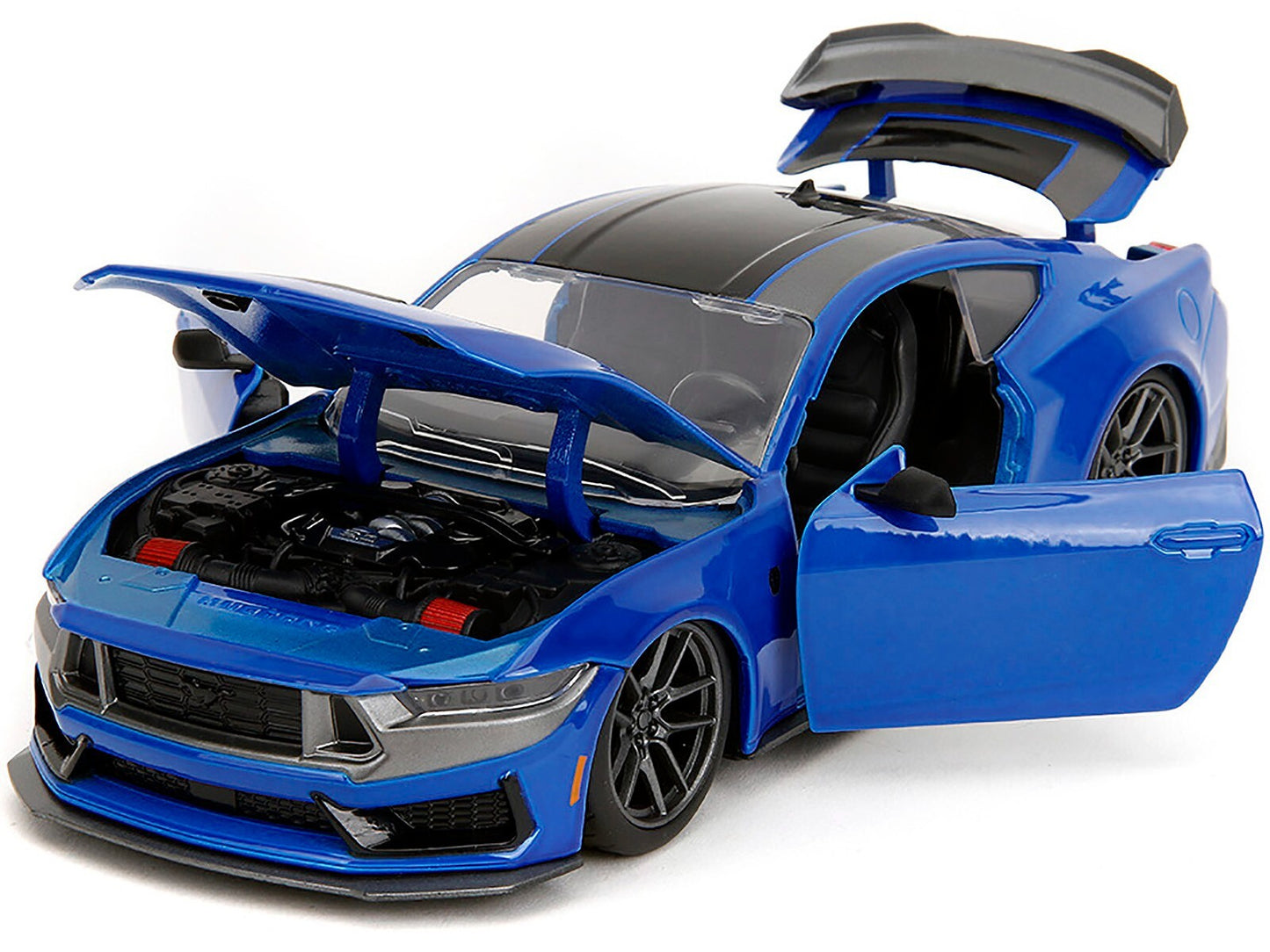 Blue toy car with open doors and hood on a white background
