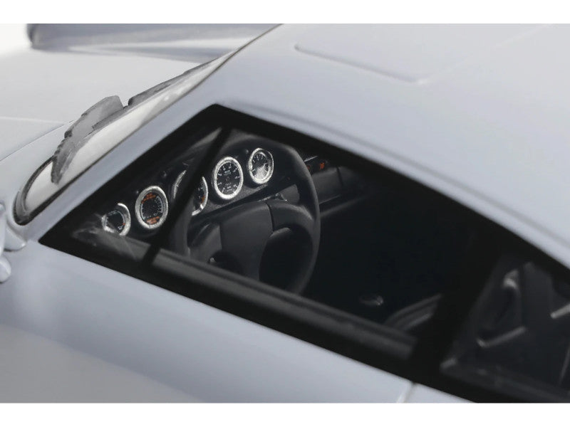 Close-up of a car's dashboard with steering wheel and gauges.
