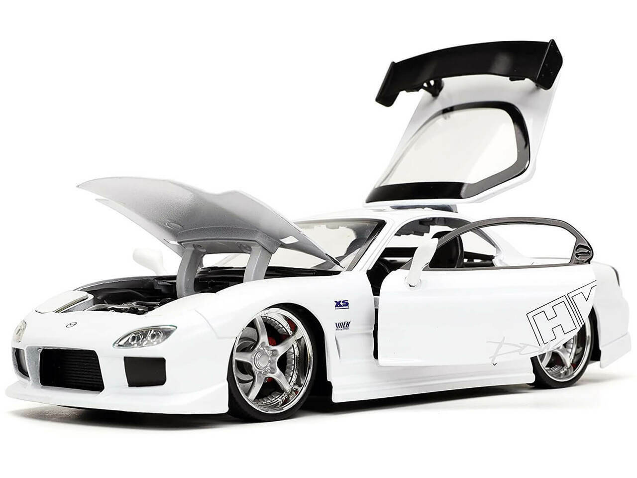 White sports car with open gull-wing doors on a white background