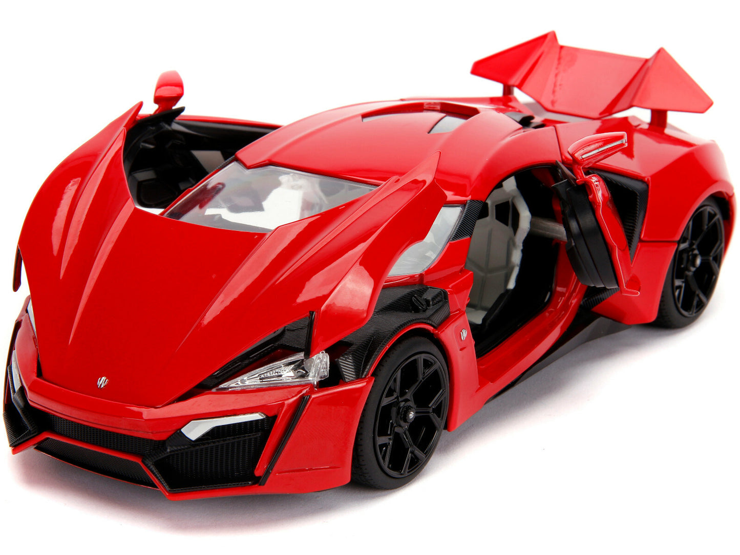 Red toy sports car with open doors on a white background