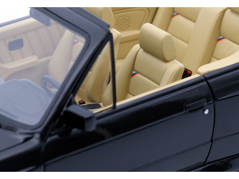 Close-up of a car interior with beige seats and a black door panel.
