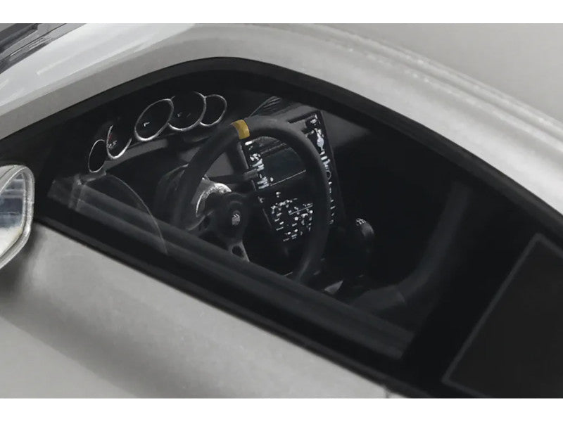 Close-up of a car's interior with steering wheel and dashboard.