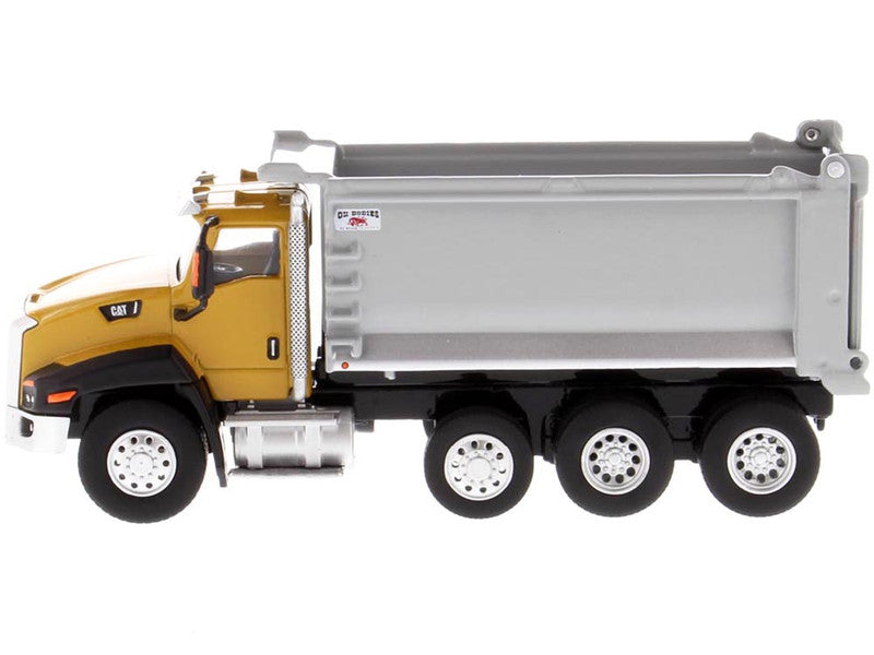 Model of a yellow dump truck with a silver bed on a white background