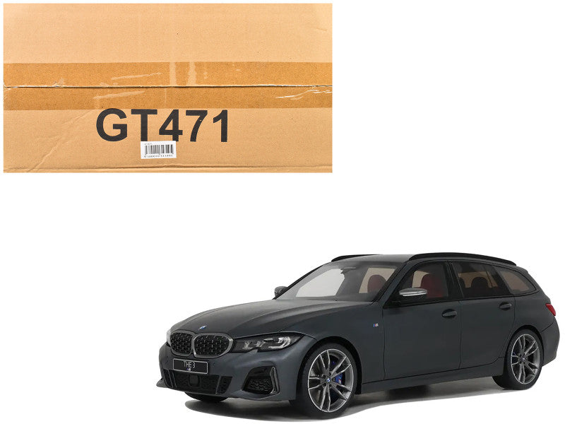 Black car model next to a cardboard box with 'GT471' on a white background
