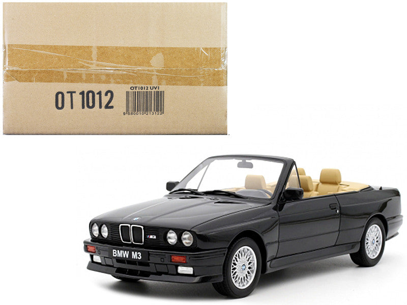 Black BMW M3 convertible model car with beige interior next to a cardboard box labeled OT1012.