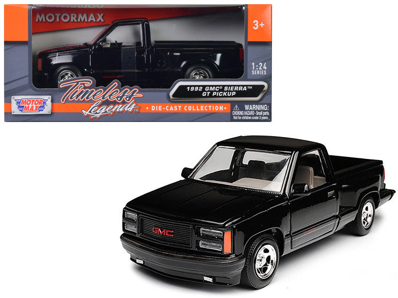 Black GMC truck model with Motormax packaging on a white background