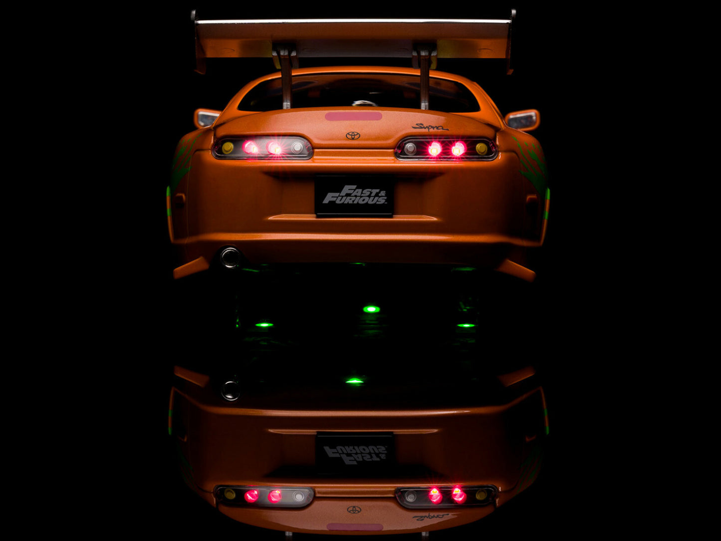 Orange toy car with visible branding on a black background