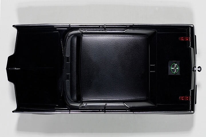 top view of a black model toy car on white background